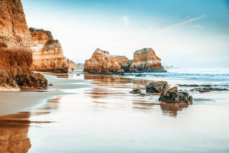beautiful ocean landscape, the coast of Portugal, the Algarve, rocks on the sandy beach, a popular destination for travel in Europe